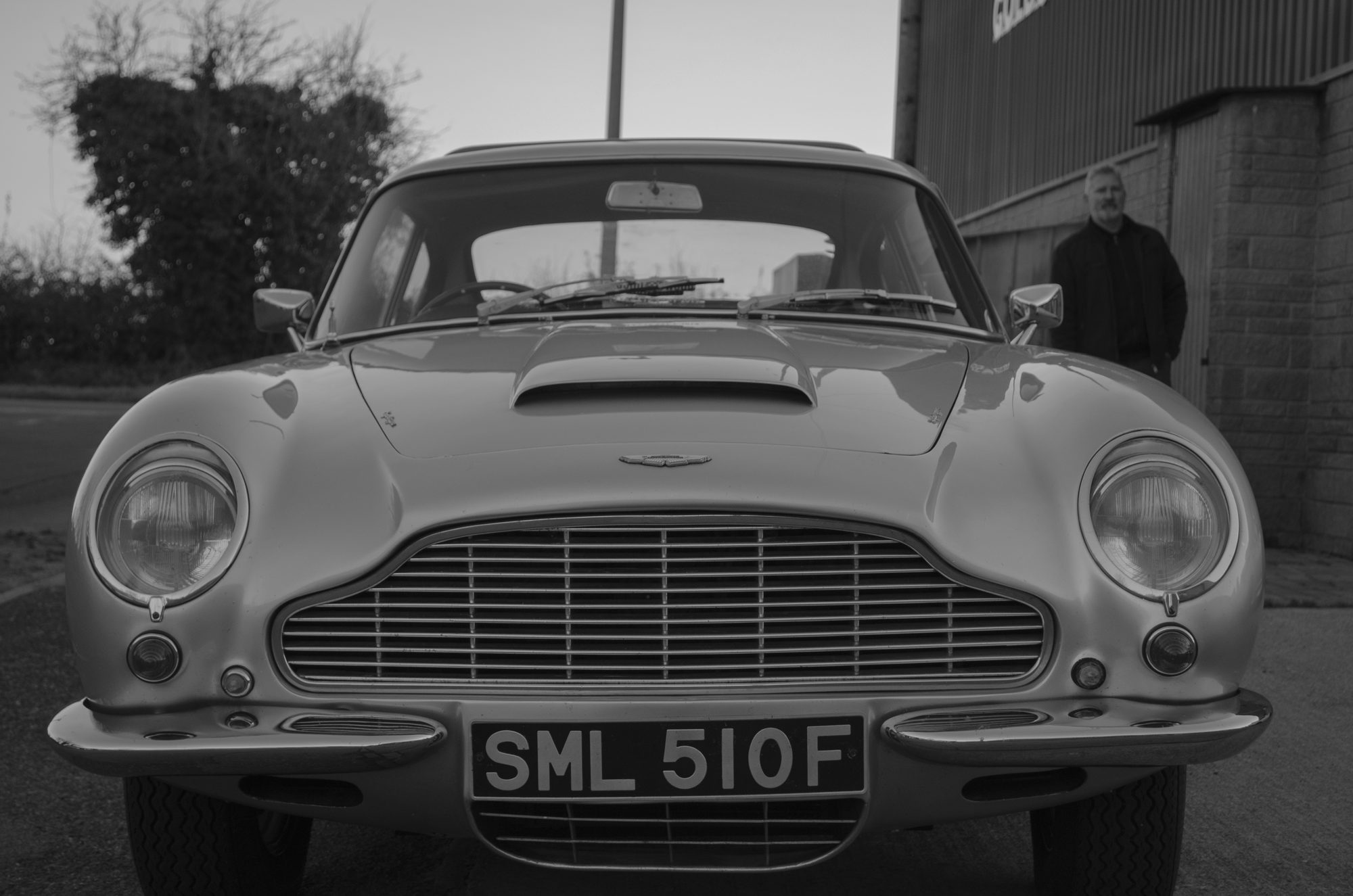 Black and white front view of a classic Aston Martin DB5